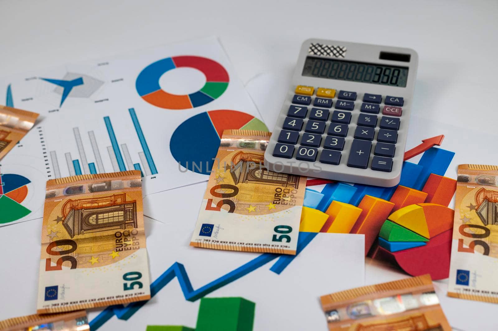 50 euro banknotes with statistics and calculator on white background