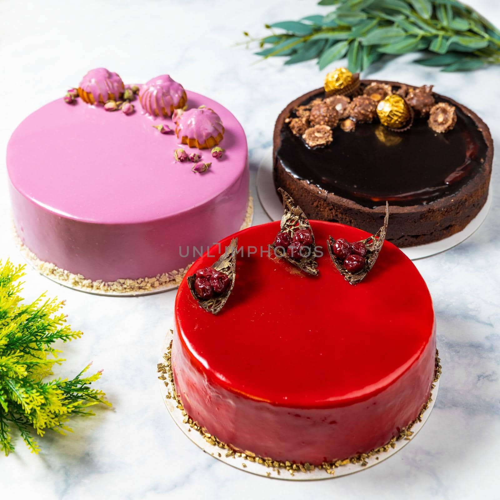 Different beautiful colorful cakes on the white table, top view