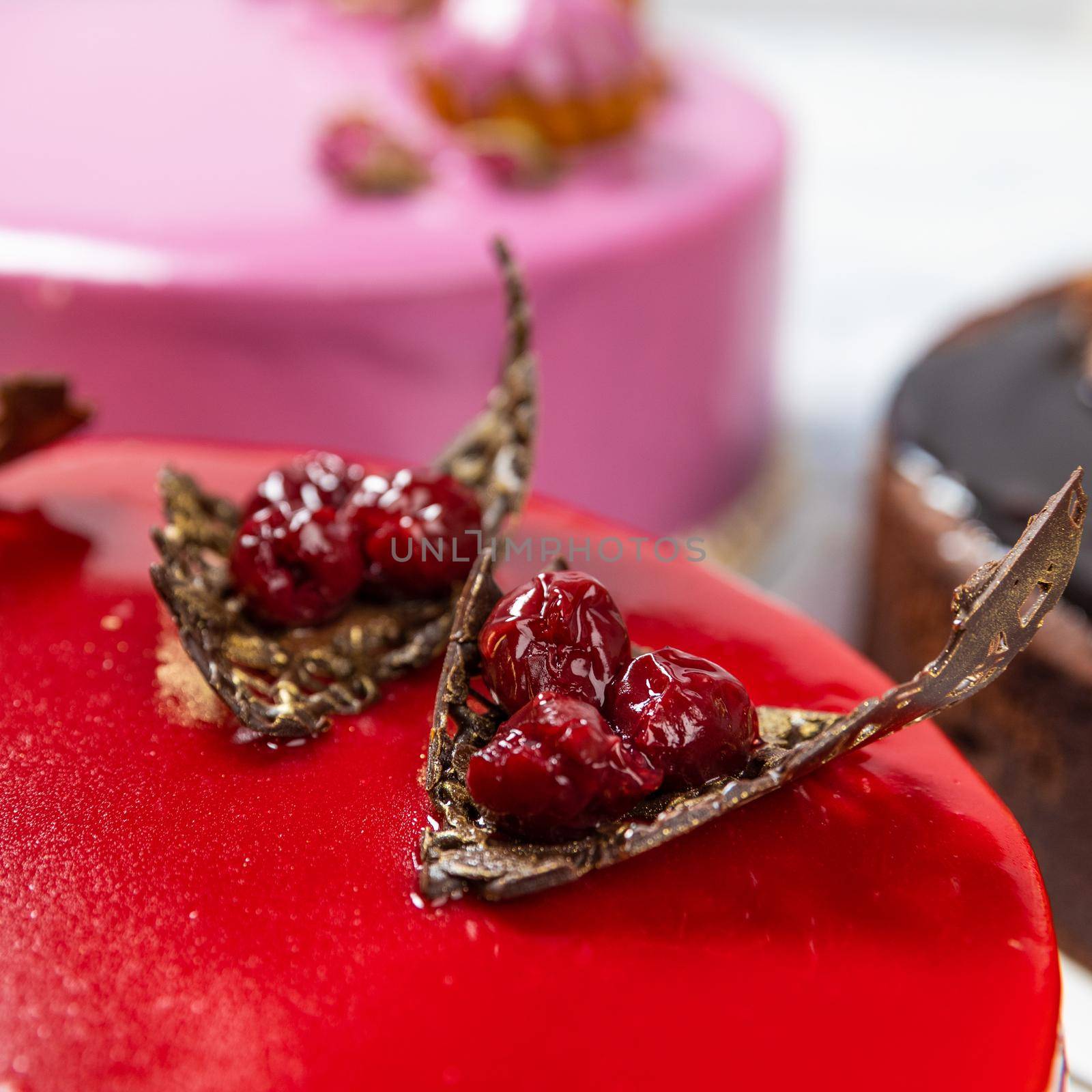 Beautiful red jam cake on the white background, cherry close up