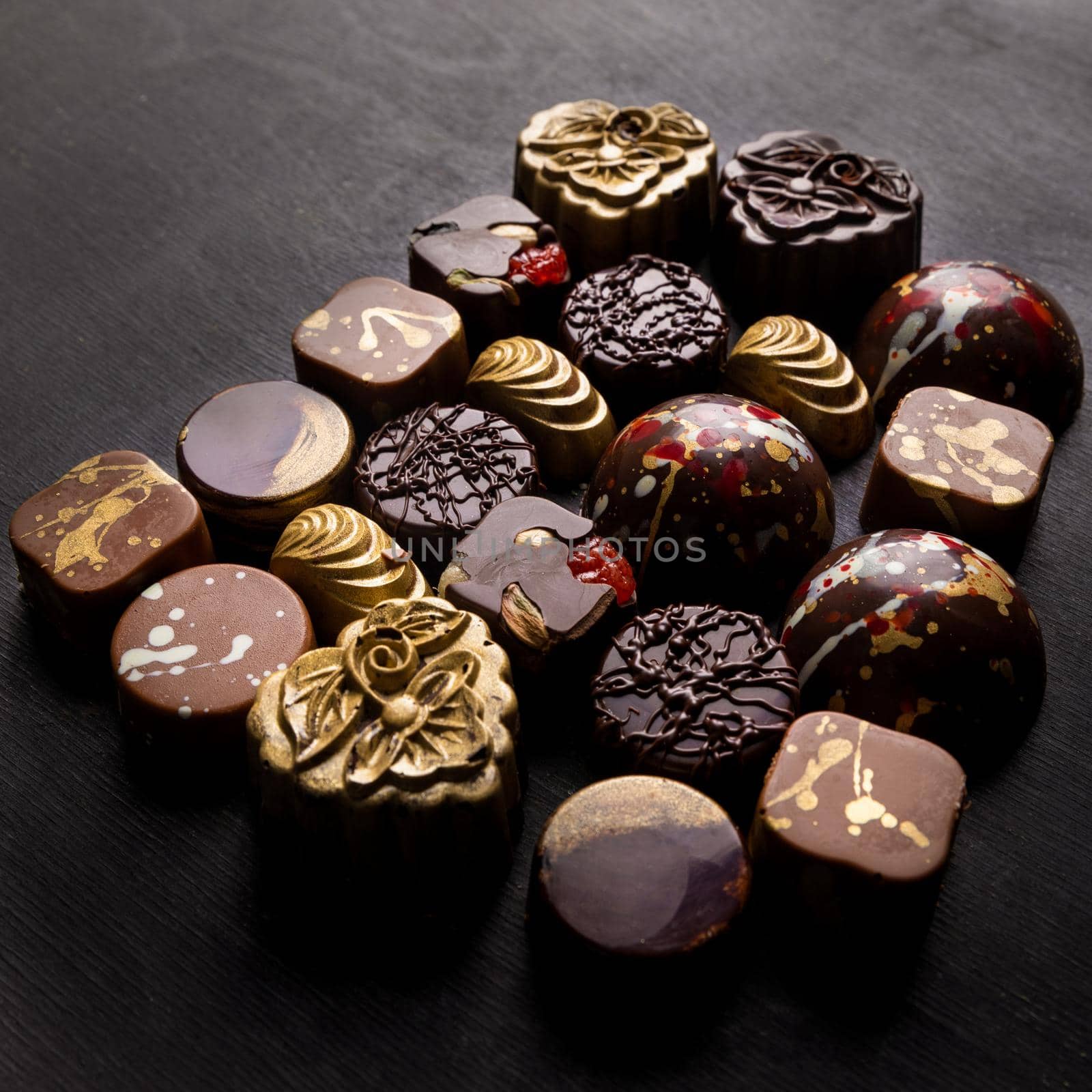 Luxury chocolate pieces on the black background, top view by ferhad