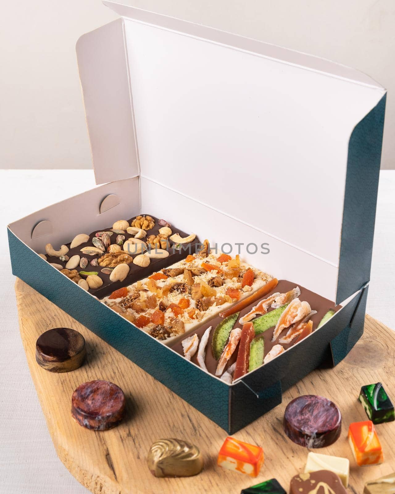 Luxury chocolate pieces, rose, pomegranate, nuts in the box by ferhad