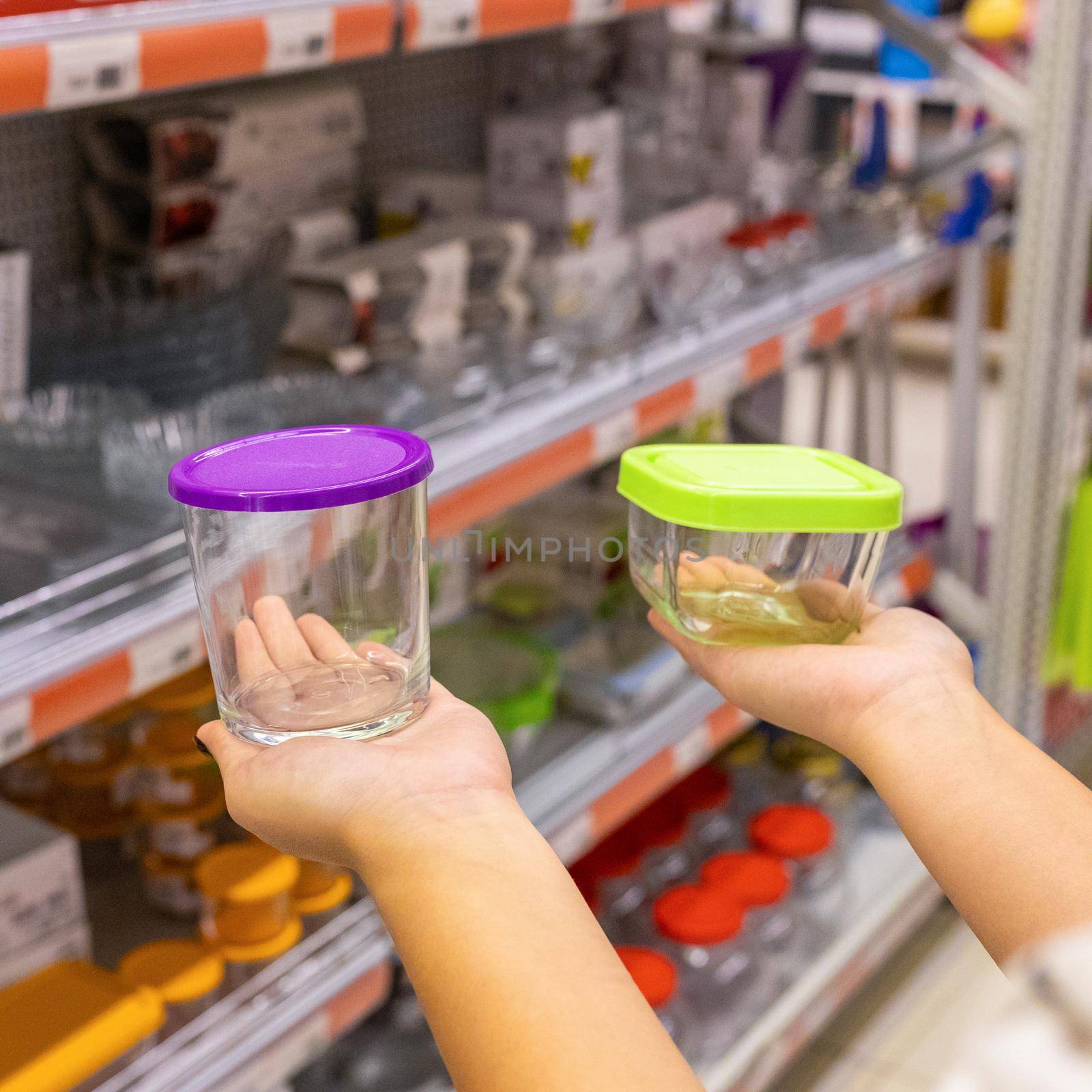 Woman holding glass food container at the store