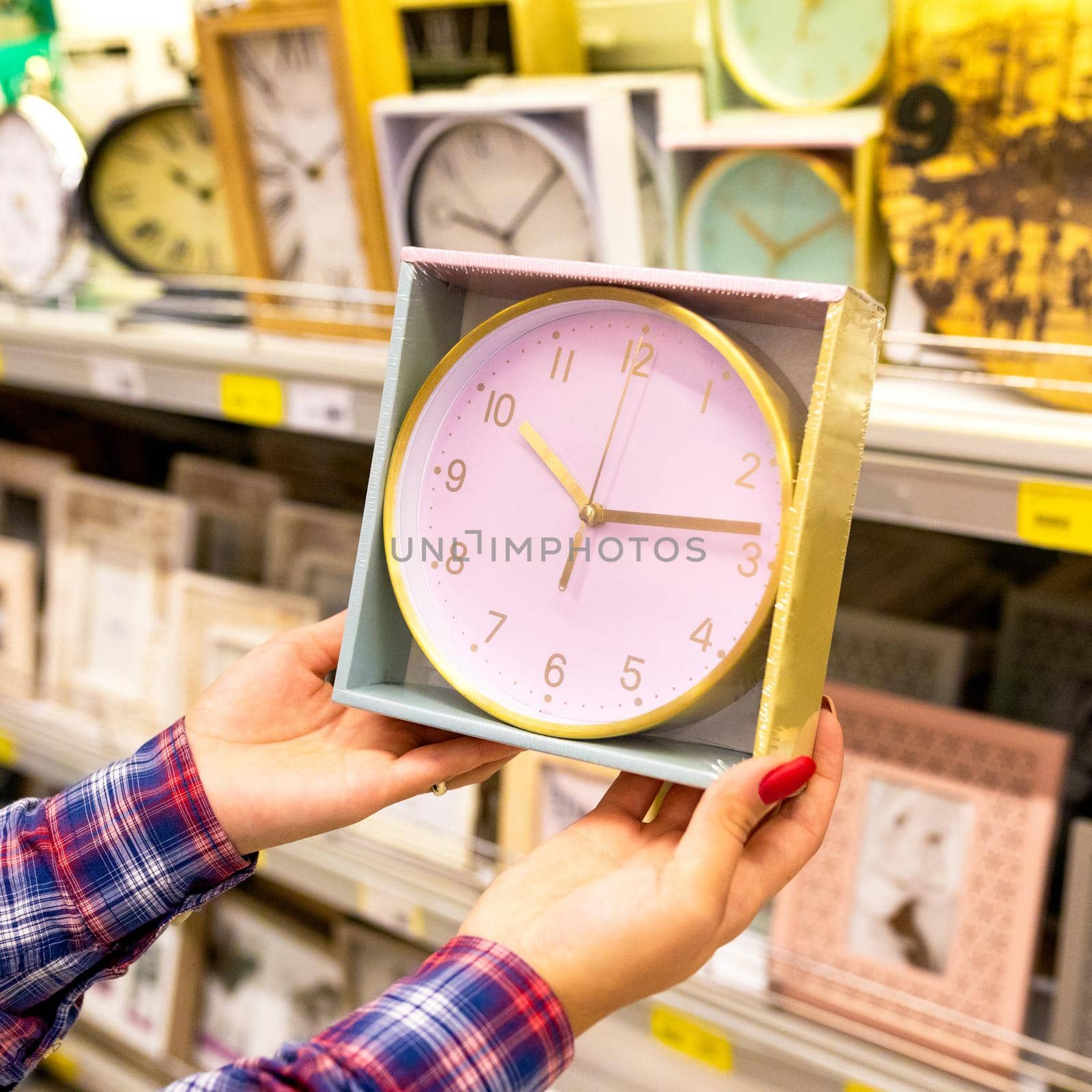 Woman holding new wall clock at the store by ferhad