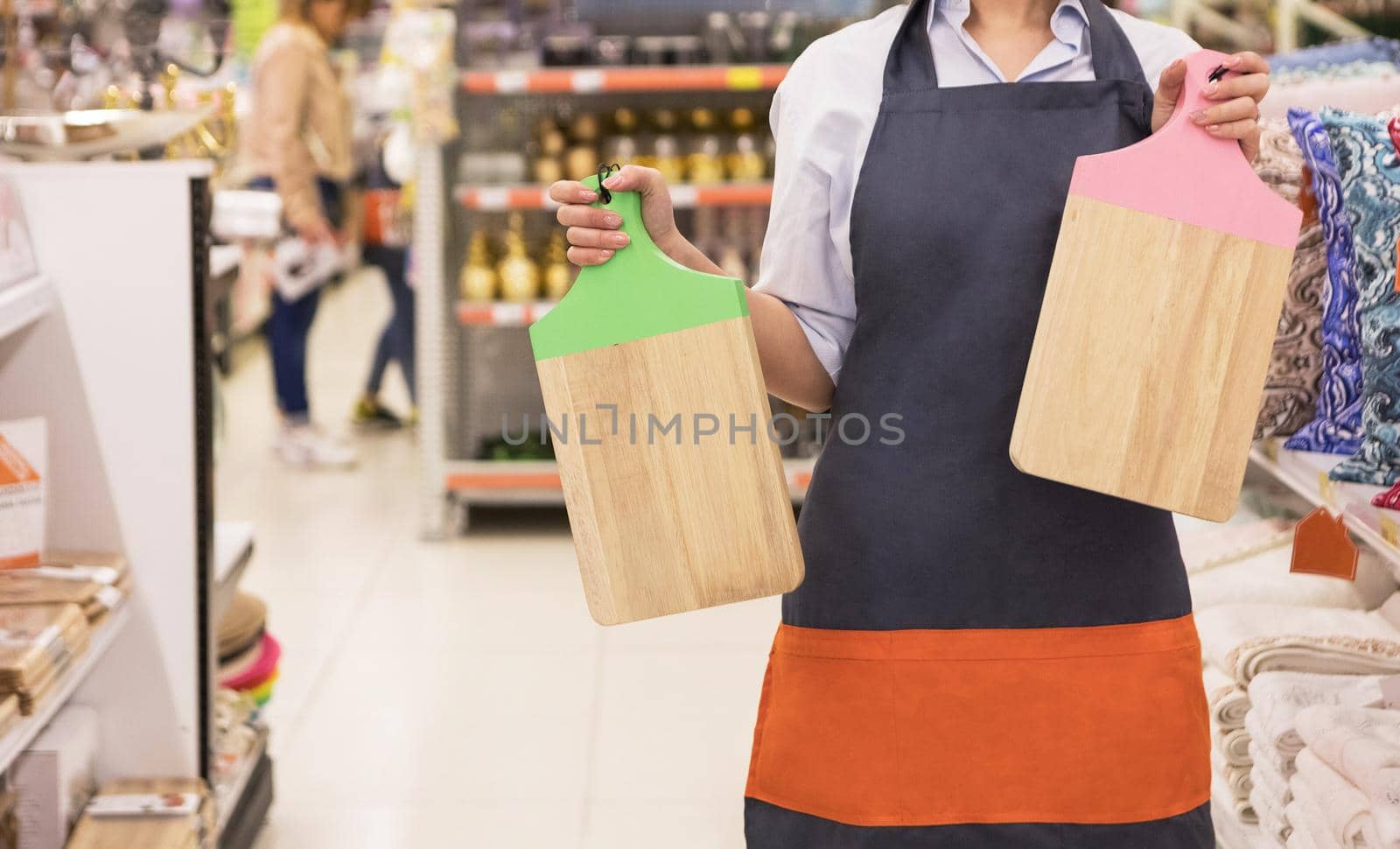 Woman holding wood cutting board at the store