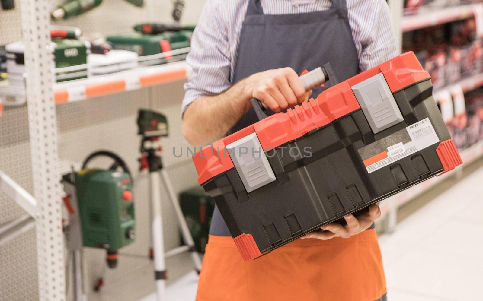 Man holding heavy duty plastic tool box at the store
