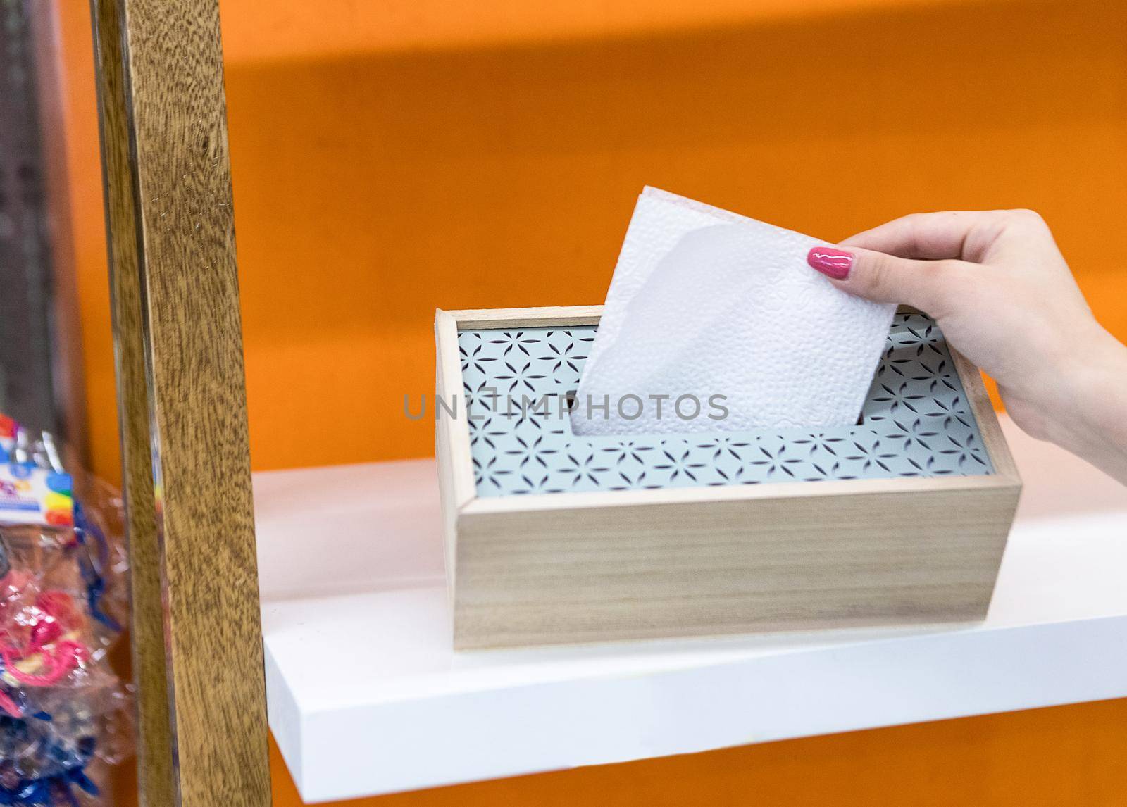 Woman taking napkin from the box isolated by ferhad