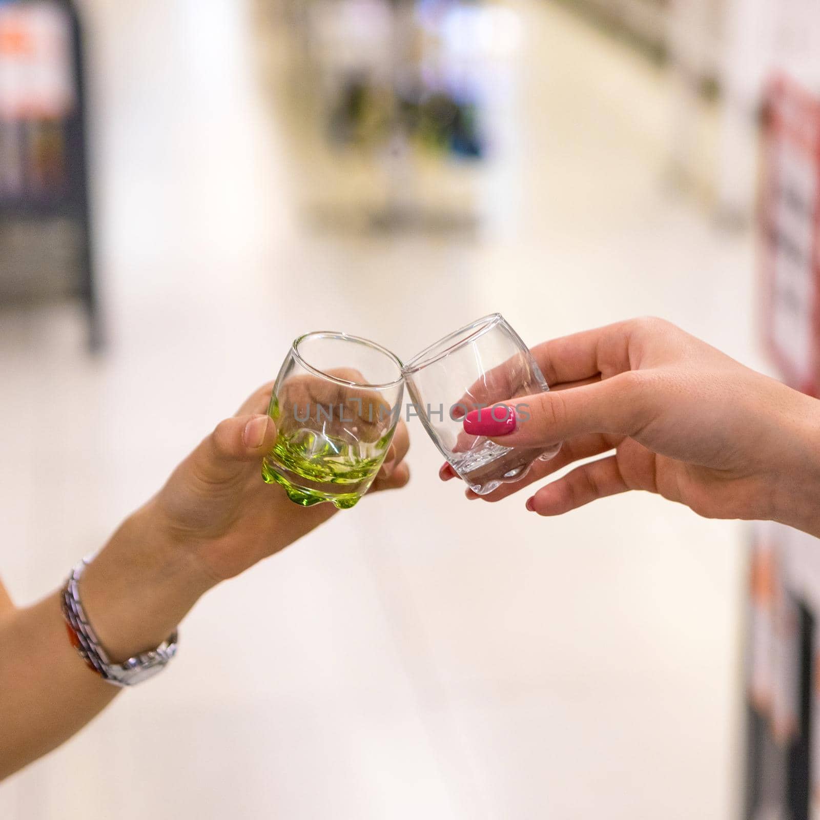 Woman clinking small drink glasses