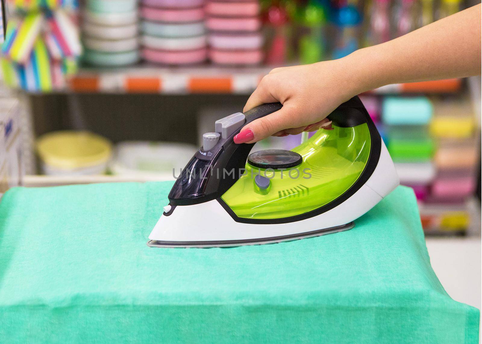 Woman ironing close up at the store