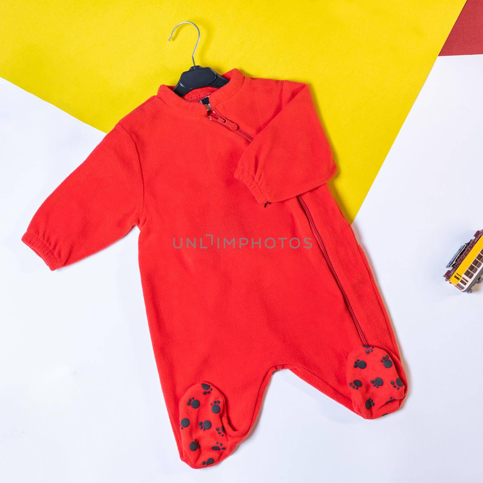 Kids red sports suit isolated on colorful background