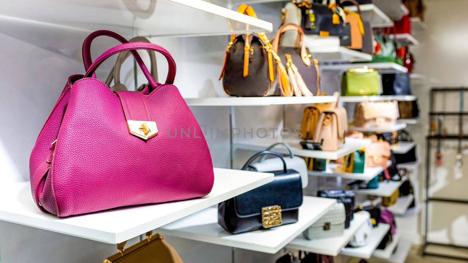 Handbags in a luxury fashion store by ferhad