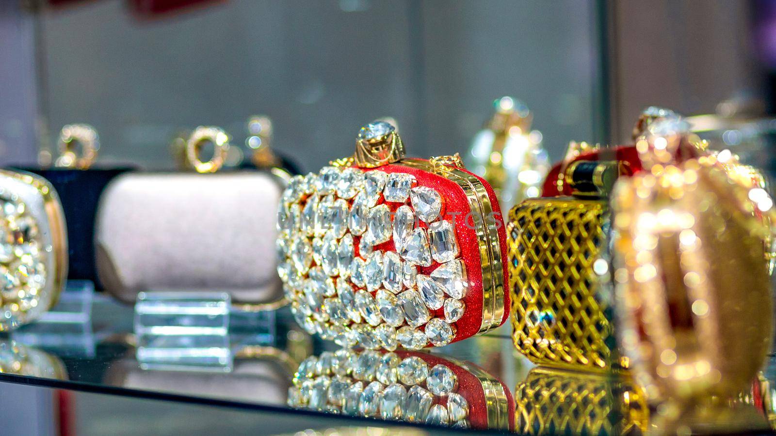 Colorful shiny diamond women handbags in a store