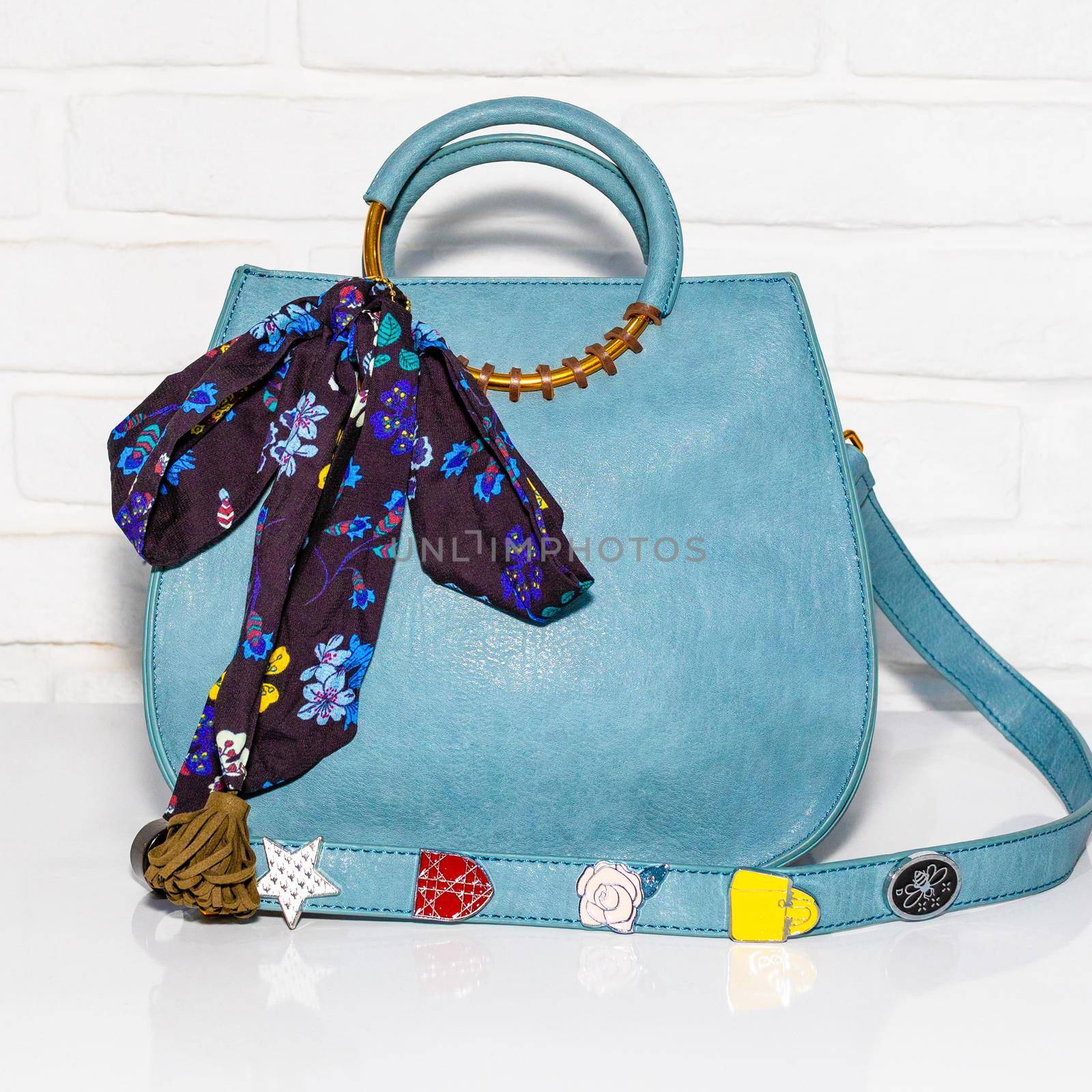 Blue female bag with scarf on a white background isolated