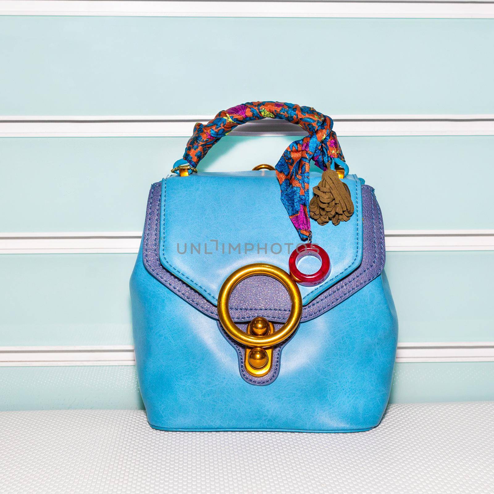 Blue female bag with scarf on a white background isolated
