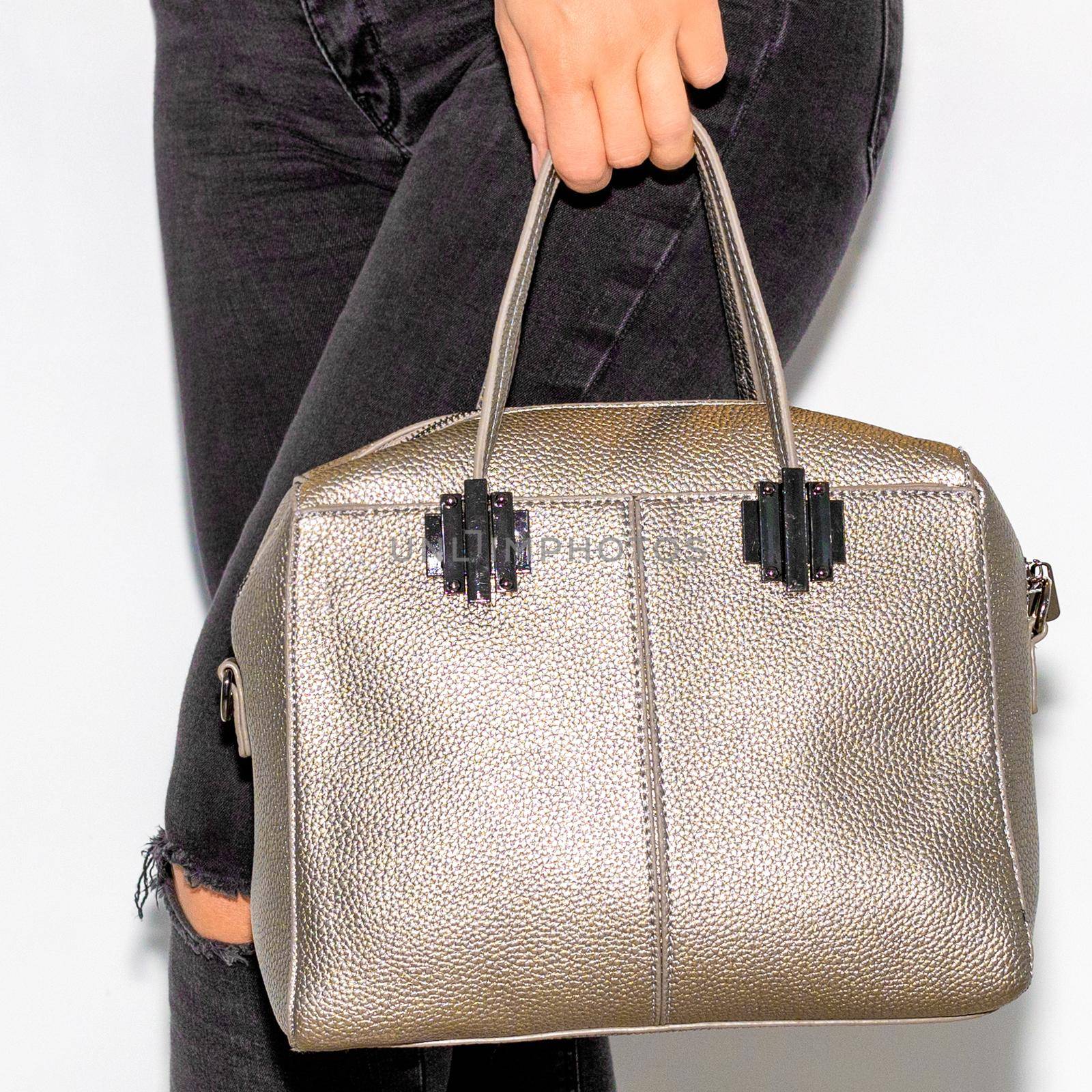 Woman holding brown leather handbag close-up by ferhad