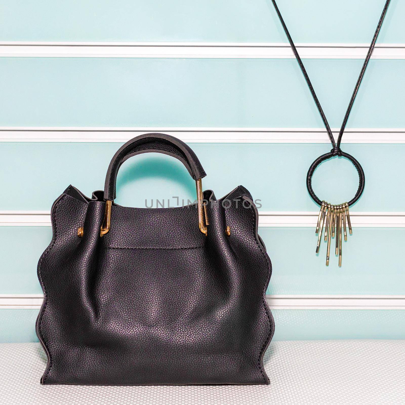 Black female bag with accessorize on a white background isolated by ferhad