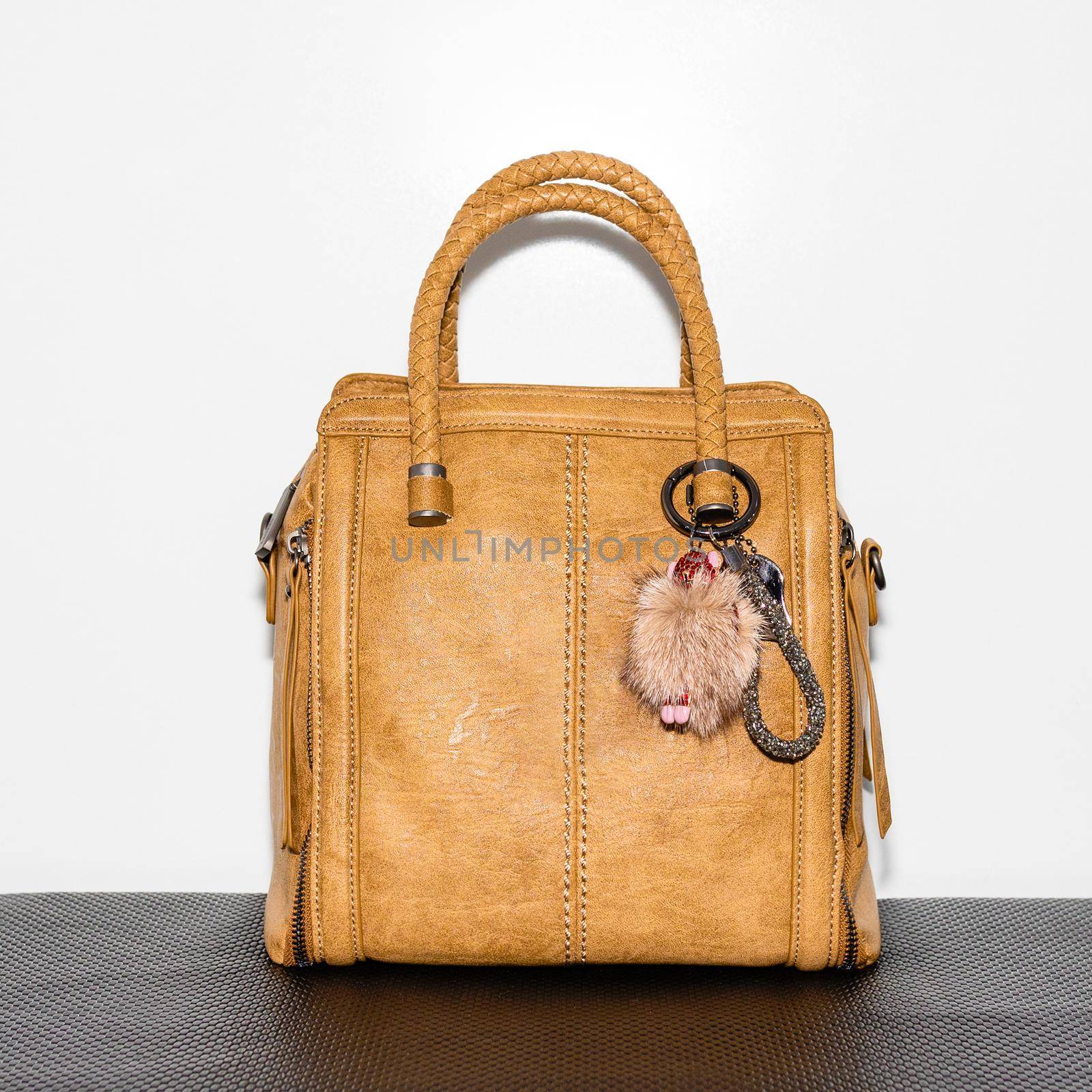 Yellow female bag with accessorize on a white background isolated