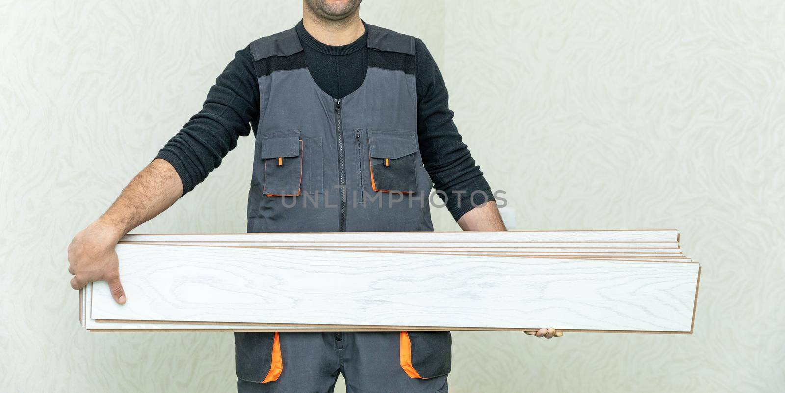 Worker man holding white wood laminate by ferhad