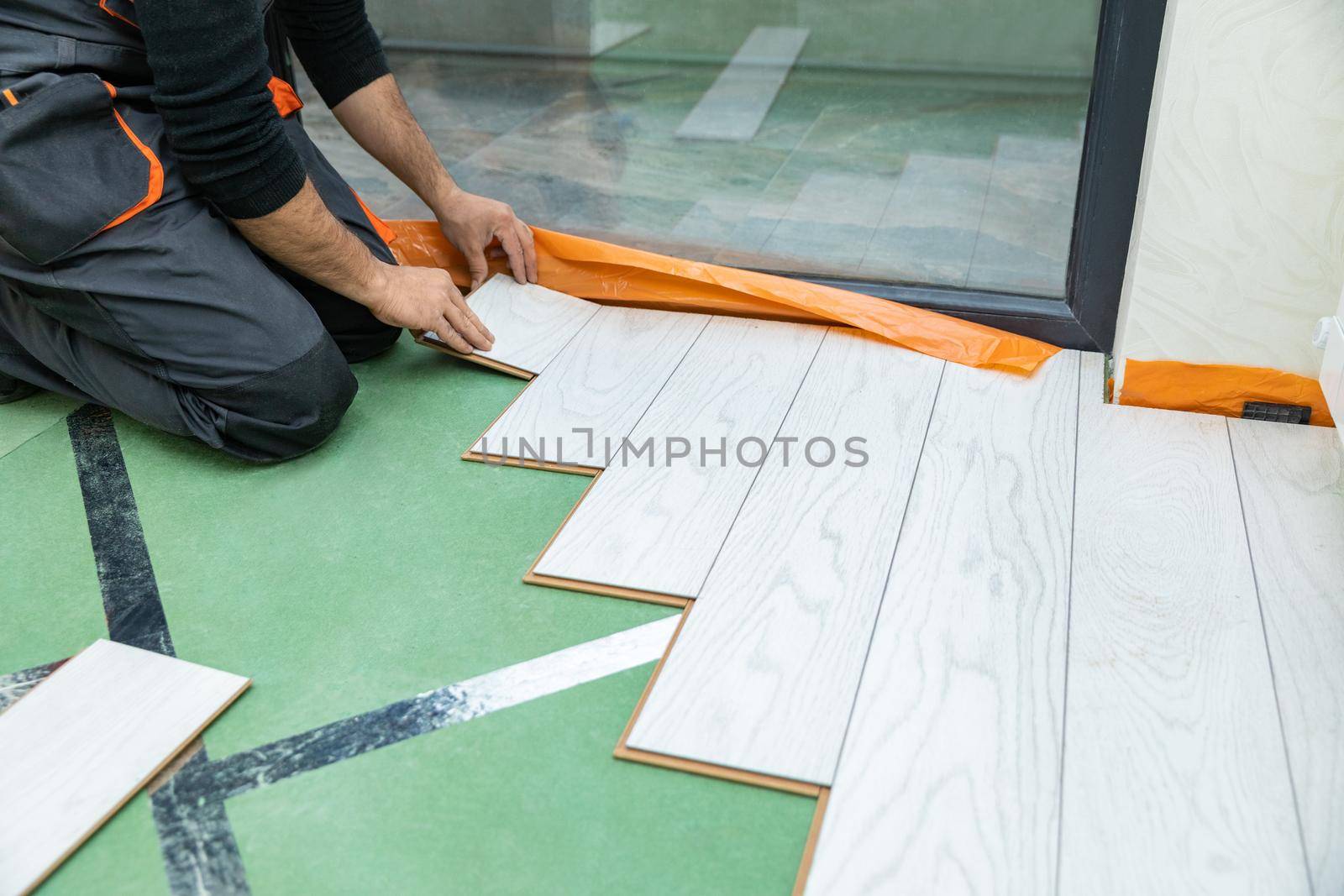 Man installing new laminated wooden floor