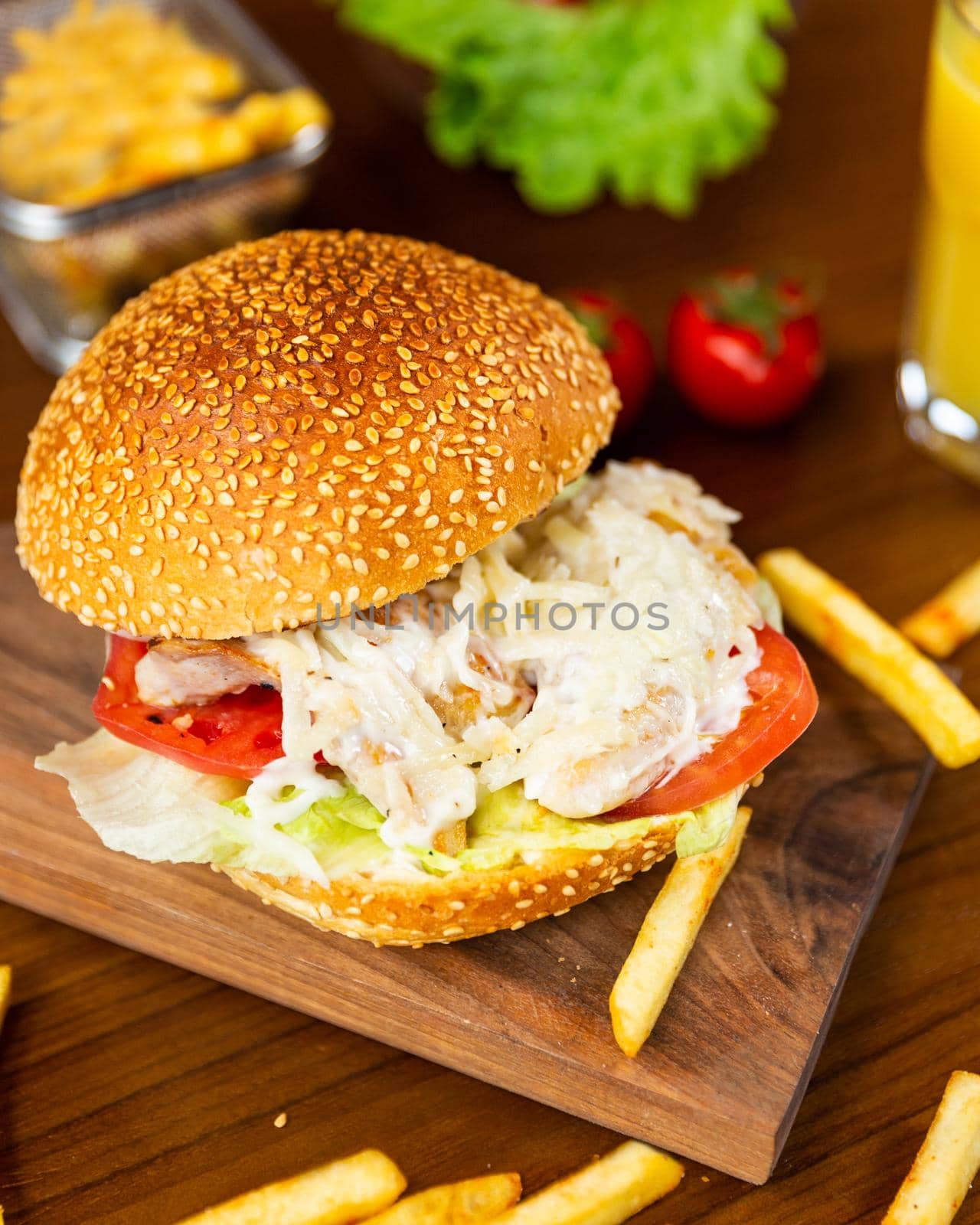 Caesar burger, french fries on the wood plate close up by ferhad