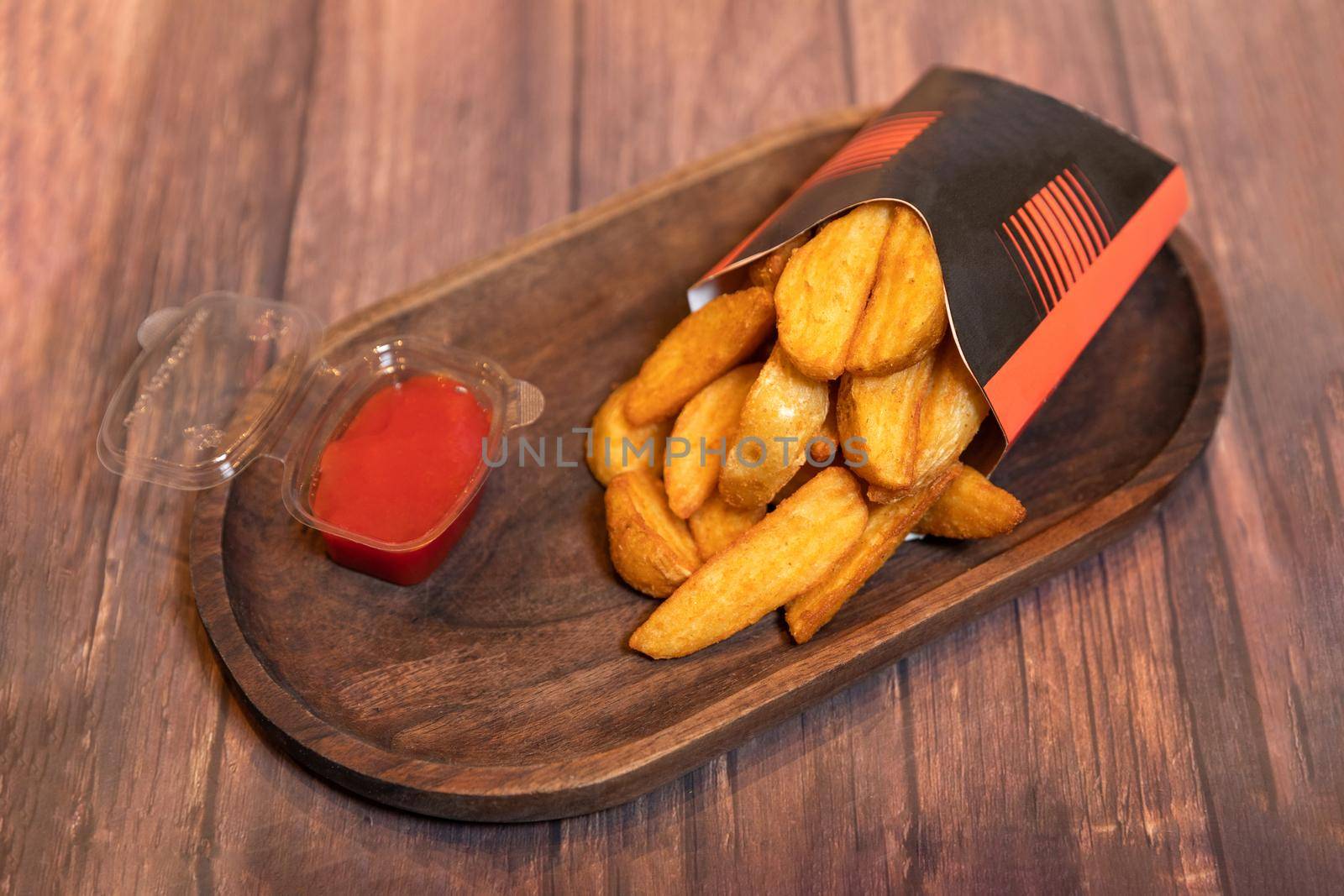 Tasty fried potatoes with ketchup