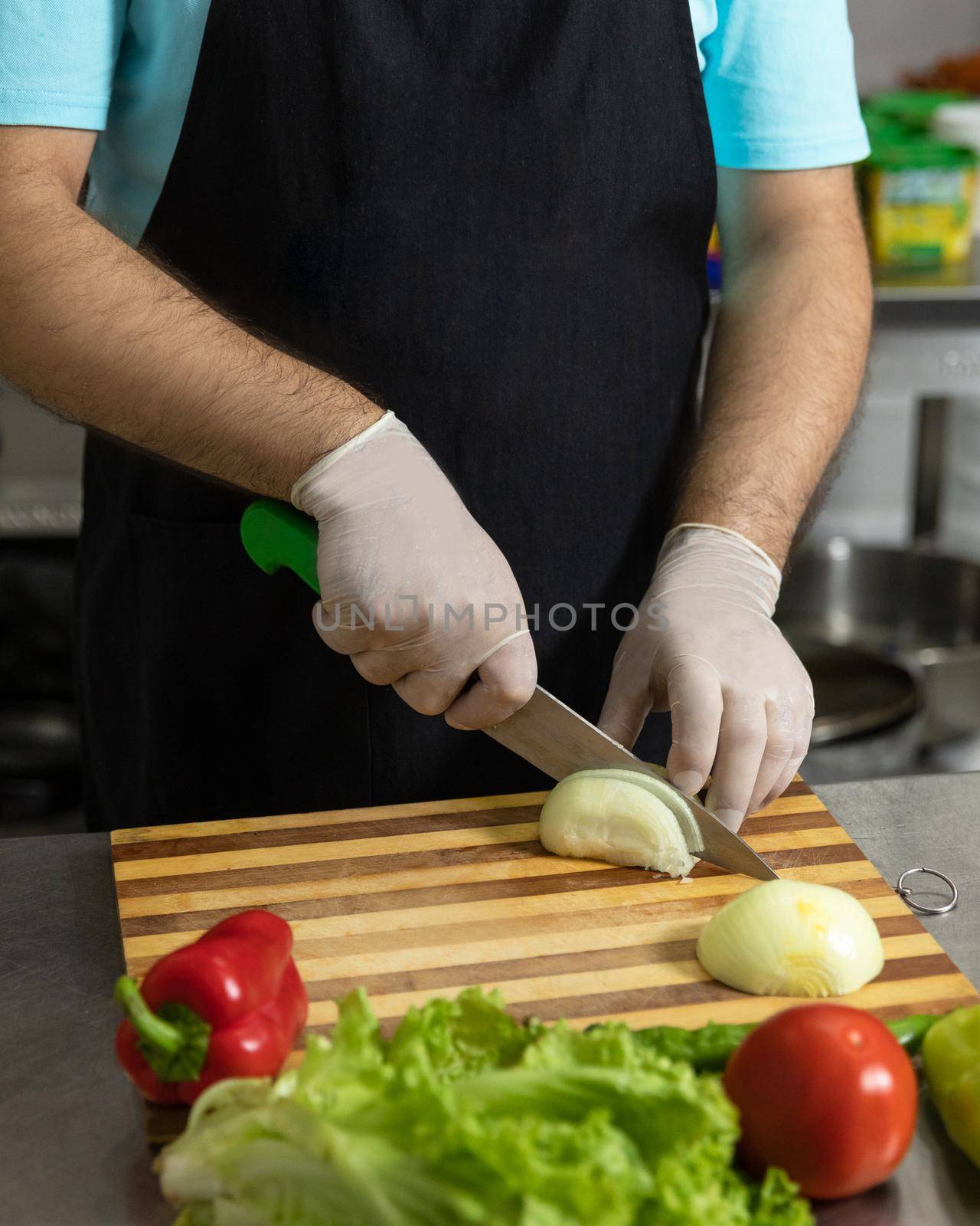 Restaurant chef making a salad, cutting onion by ferhad
