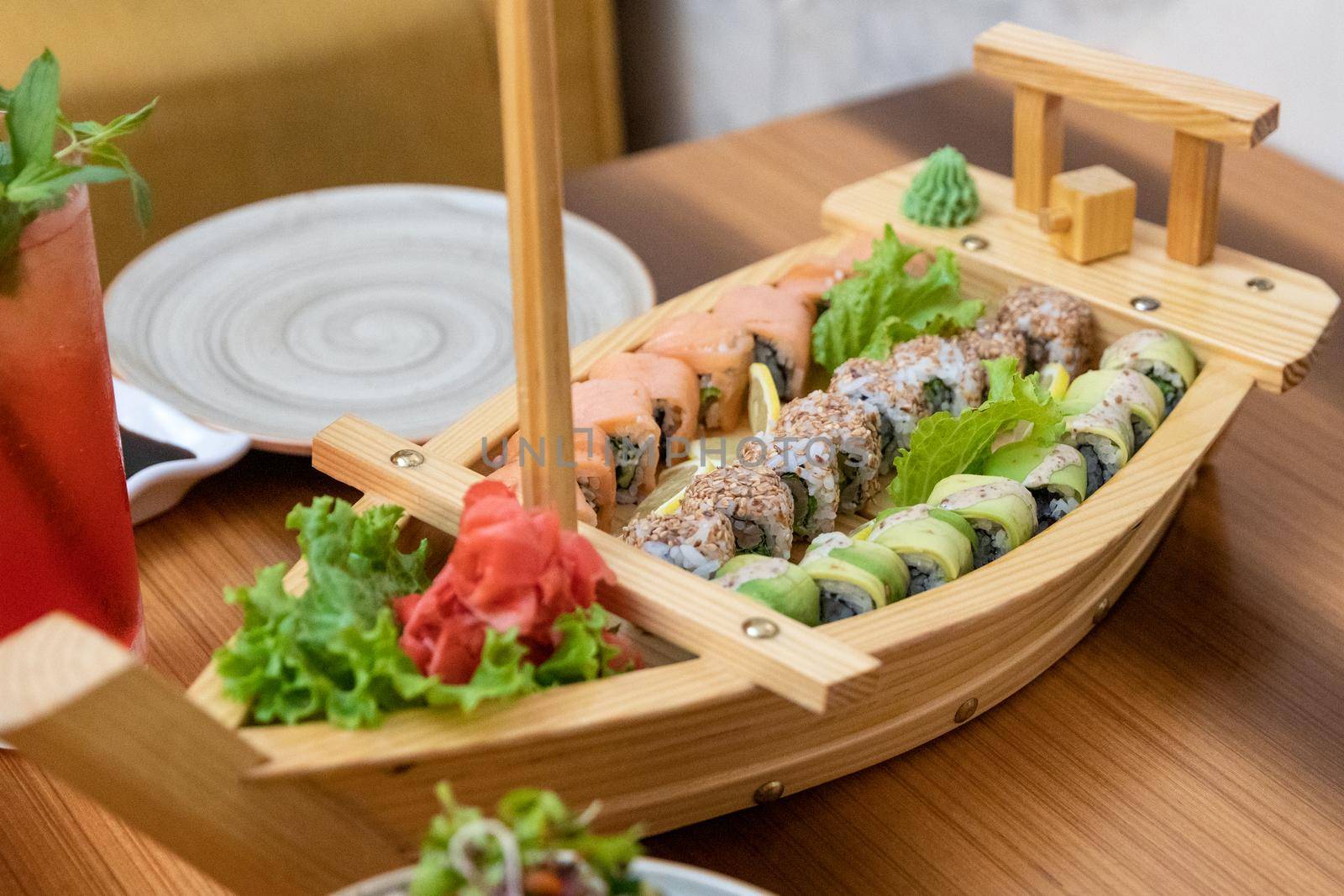 Colorful sushi set in the ship shaped plate