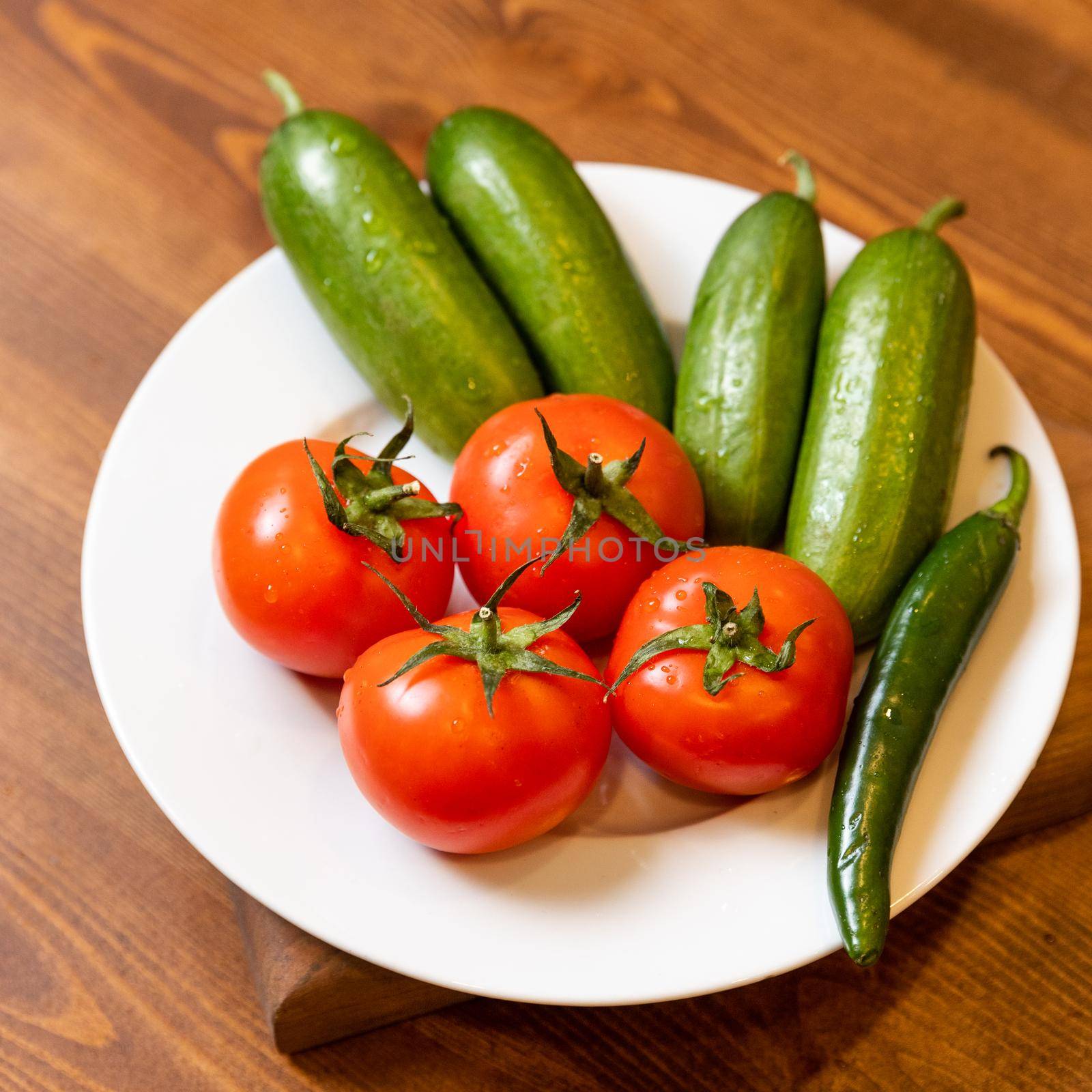 Natural fresh tomato, cucumber on the plate by ferhad