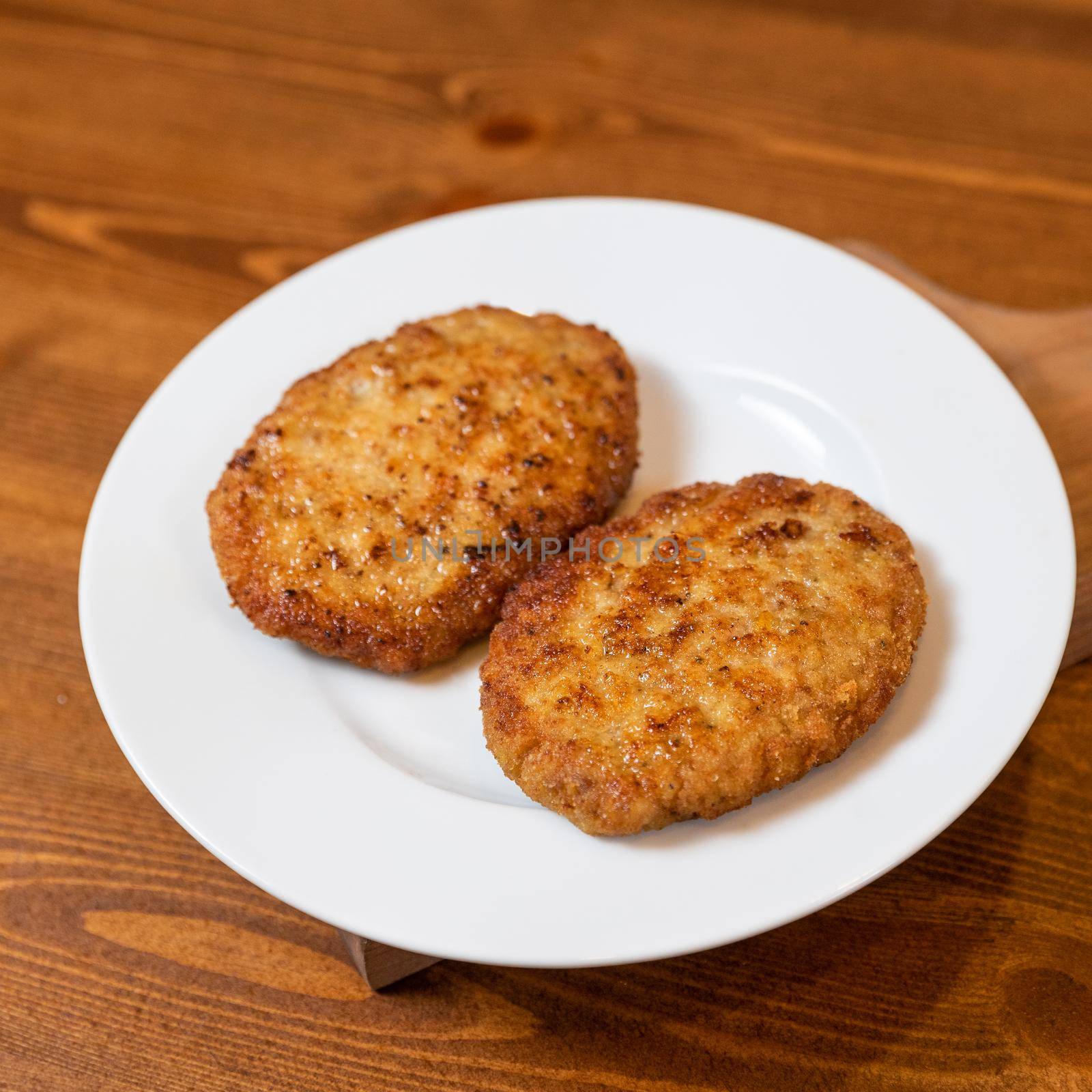 Chicken cutlet on the plate close up by ferhad