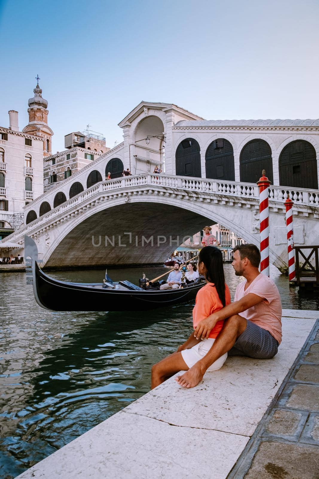 couple men and woman on a city trip to Venice Italy, colorful streets with canals Venice. Europe