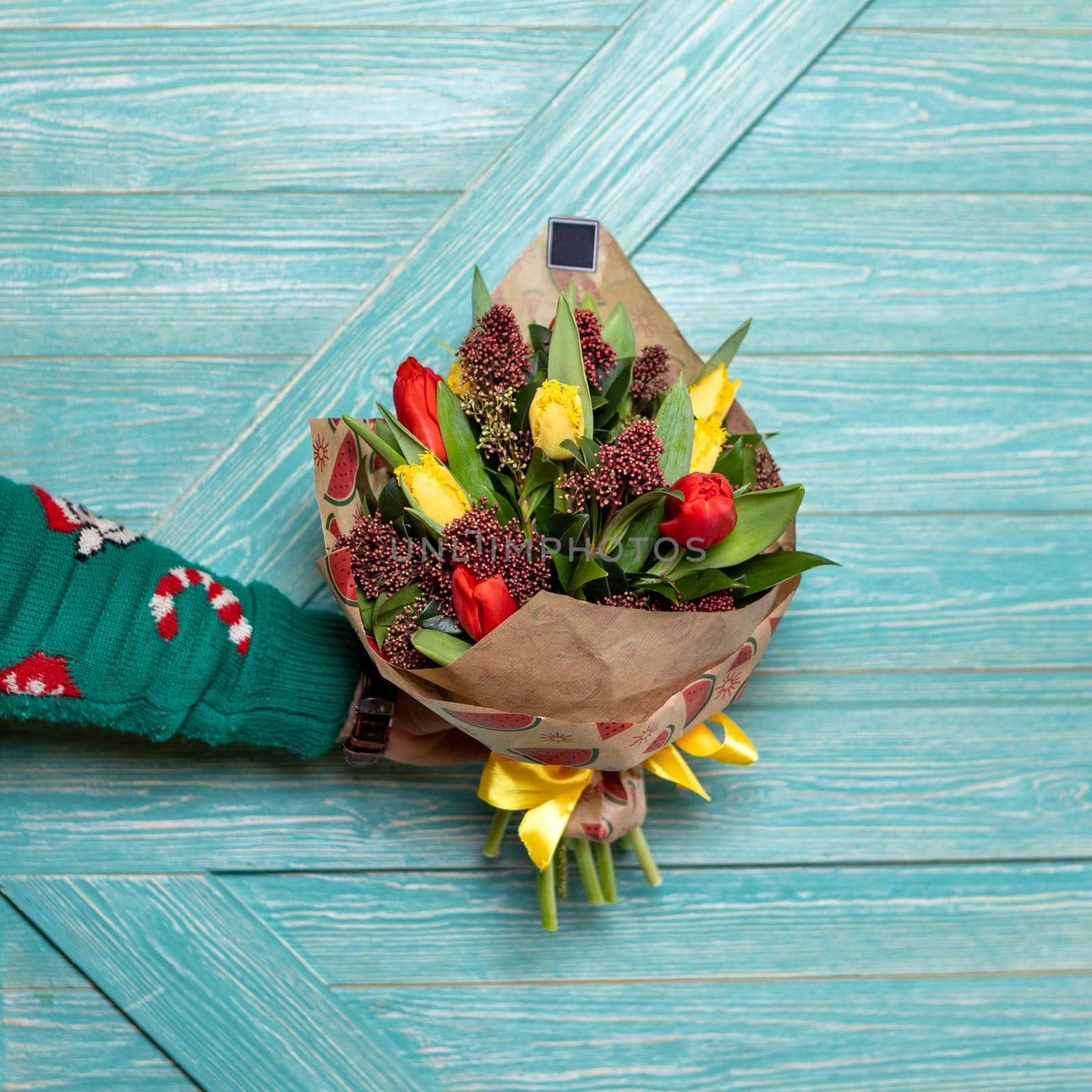 Man holding beautiful flower bouquet with blue background