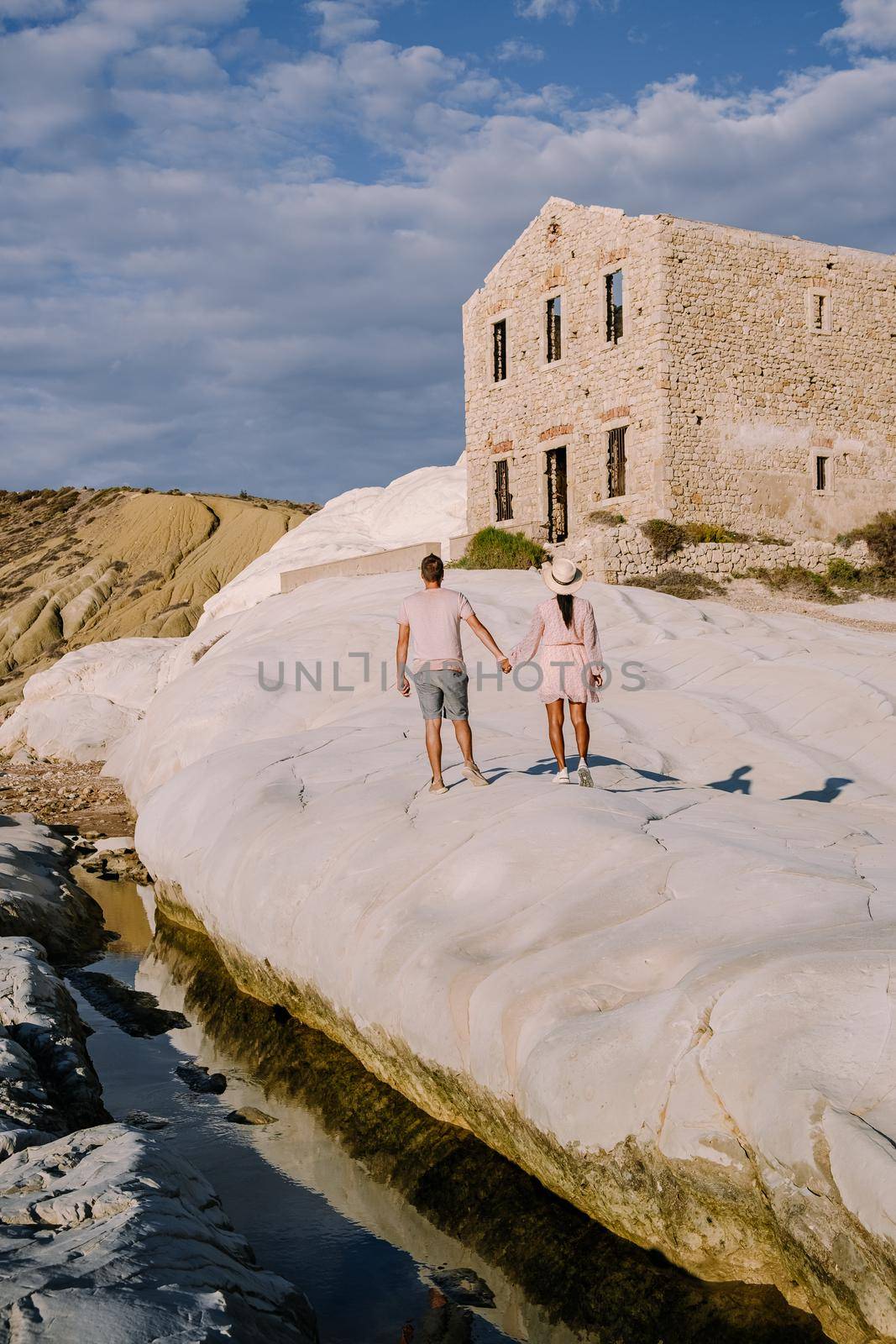 Punta Bianca, Agrigento in Sicily Italy White beach with old ruins of an abandoned stone house on white cliffs. Sicilia Italy, couple on vacation in Italy