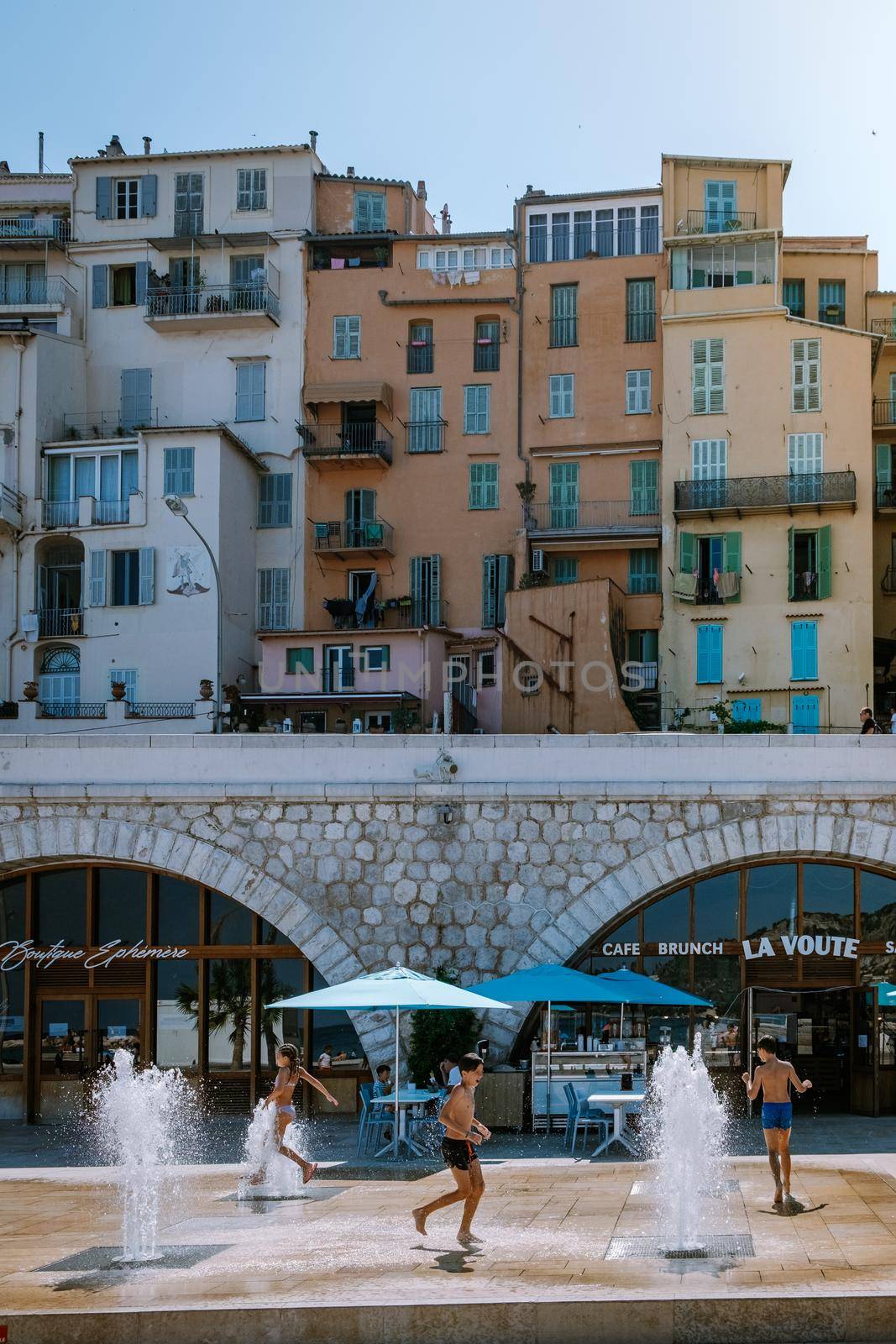 Menton France,Cote d Azur June 2020, warm hot summer day at waterfront beach and a view on old part of Menton, Provence-Alpes-Cote d'Azur, France by fokkebok