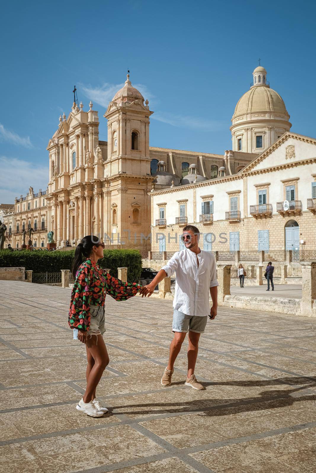 Sicily Italy, view of Noto old town and Noto Cathedral, Sicily, Italy. beautiful and typical streets and stairs in the baroque town of Noto in the province of Syracuse in Sicily, a couple on city trip Noto