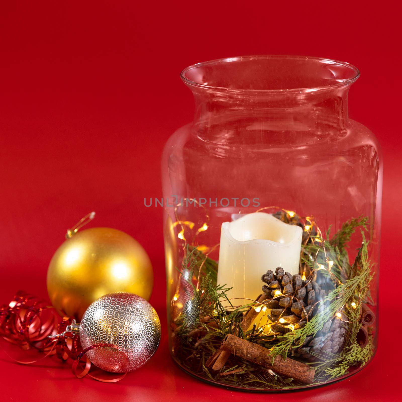 Christmas toy, decor, candle in the jar, red background