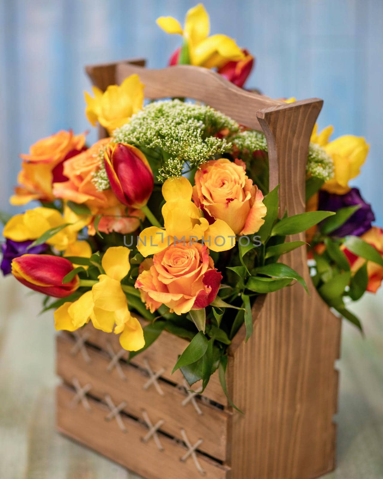 Colorful flower bouquet in the wood box with blue background by ferhad