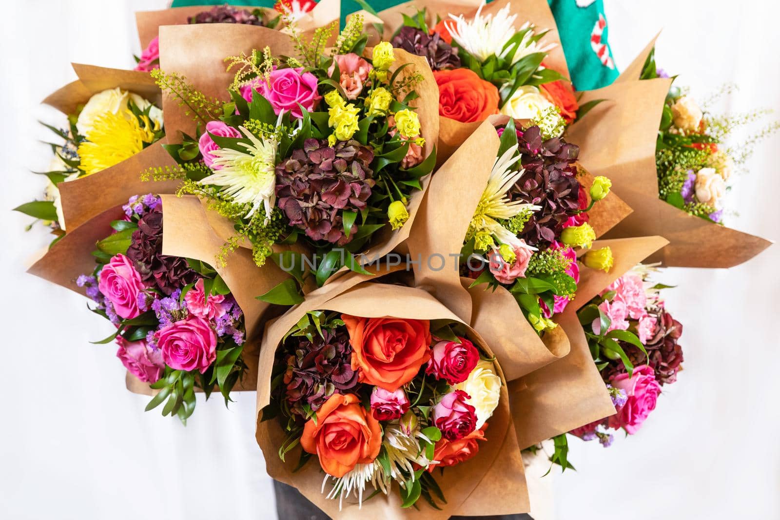 Florist holding beautiful flower bouquets