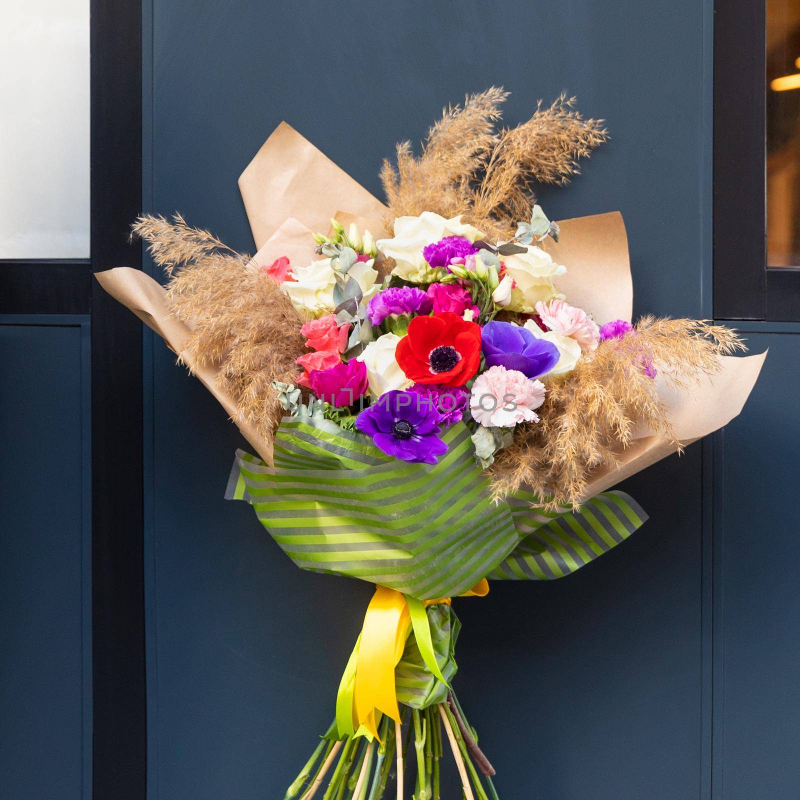 Beautiful flower bouquet with blue wall background