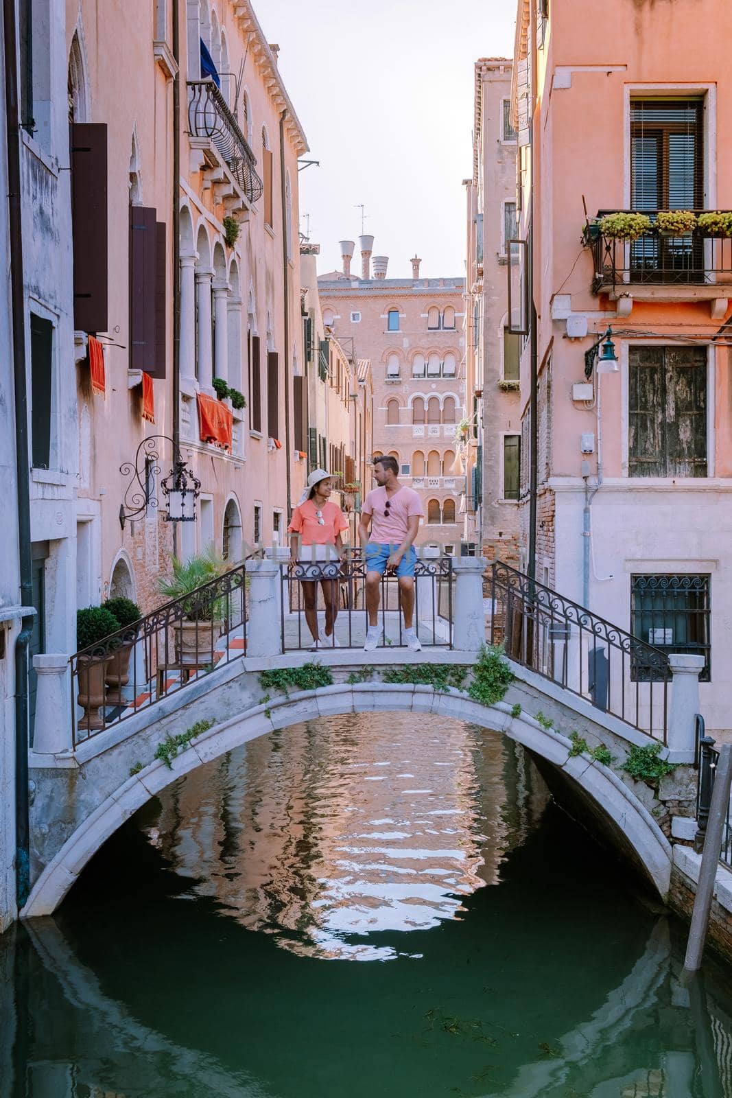 couple men and woman on a city trip to Venice Italy, colorful streets with canals Venice. Europe