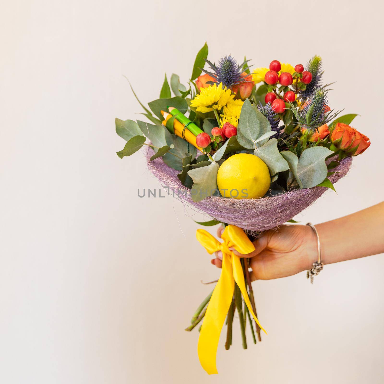 Woman holding colorful flower bouquet with white background by ferhad