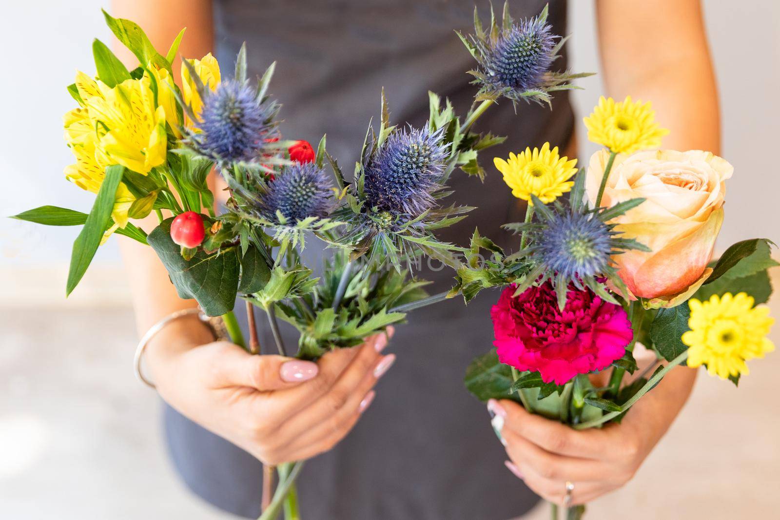 Florist woman holding flowers, Rose, Queen-of-the-alps, Eryngium alpinum by ferhad