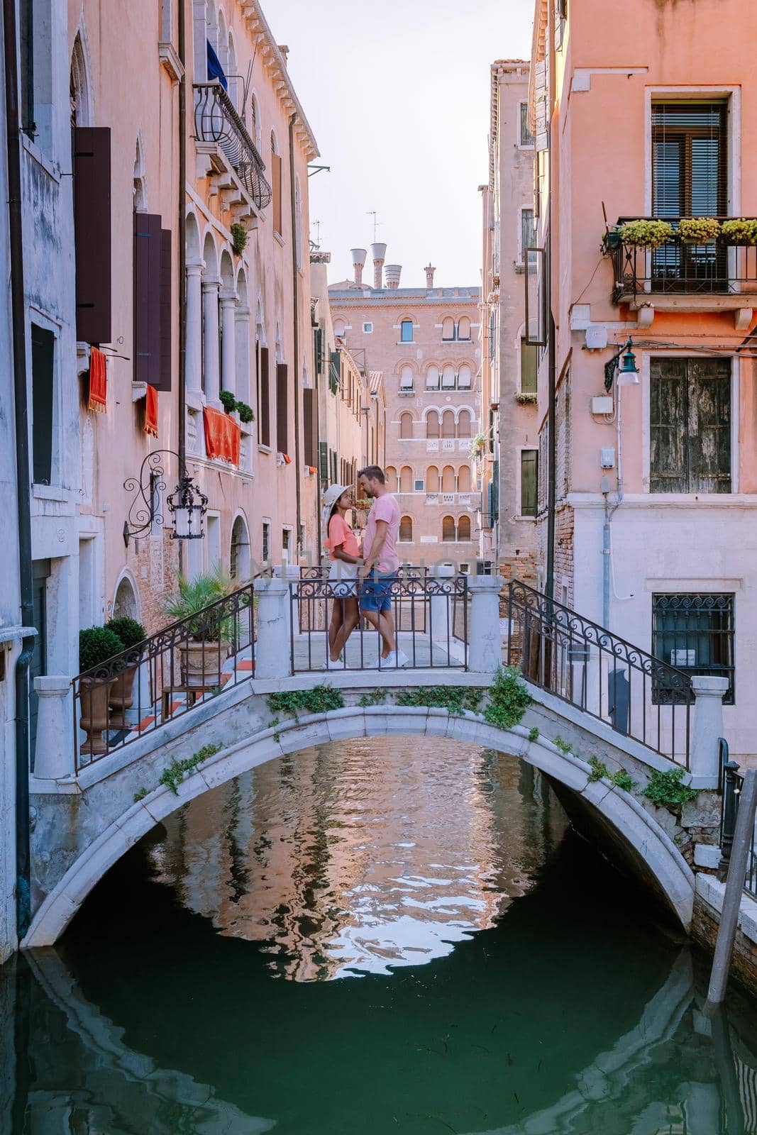 couple men and woman on a city trip to Venice Italy, colorful streets with canals Venice. Europe