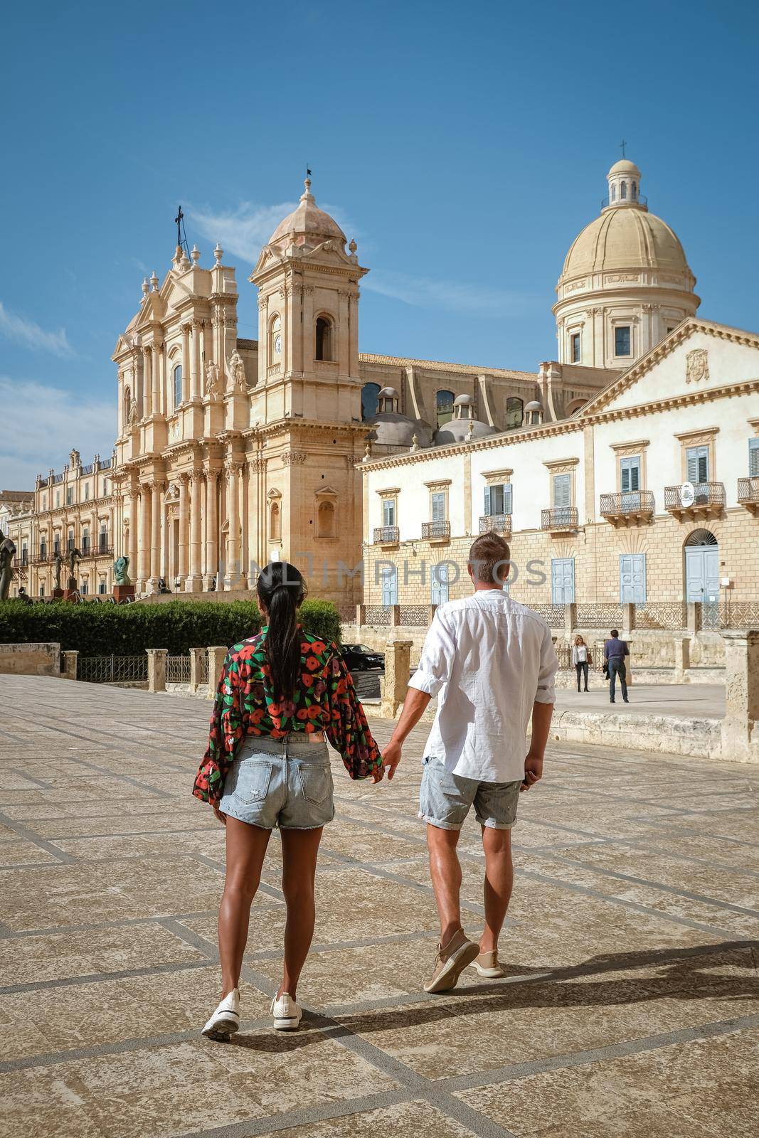 Sicily Italy, view of Noto old town and Noto Cathedral, Sicily, Italy. beautiful and typical streets and stairs in the baroque town of Noto in the province of Syracuse in Sicily, a couple on city trip Noto