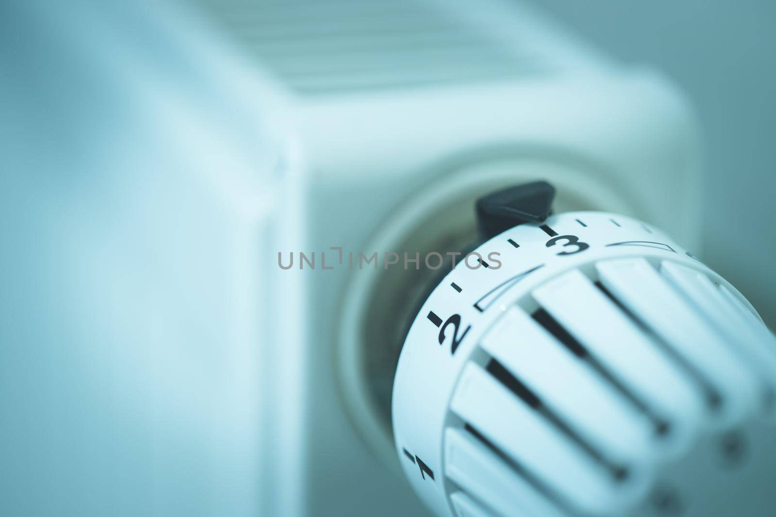 Heat regulator on a heater, close up picture. Heating Costs. by Daxenbichler