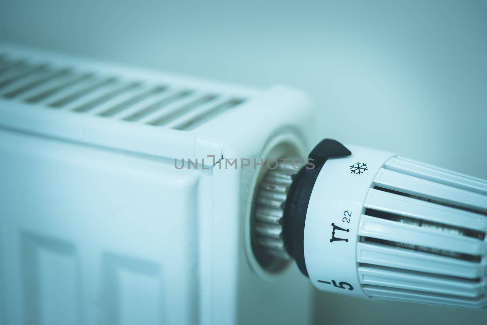 Heat regulator on a heater, close up picture. Heating Costs. by Daxenbichler