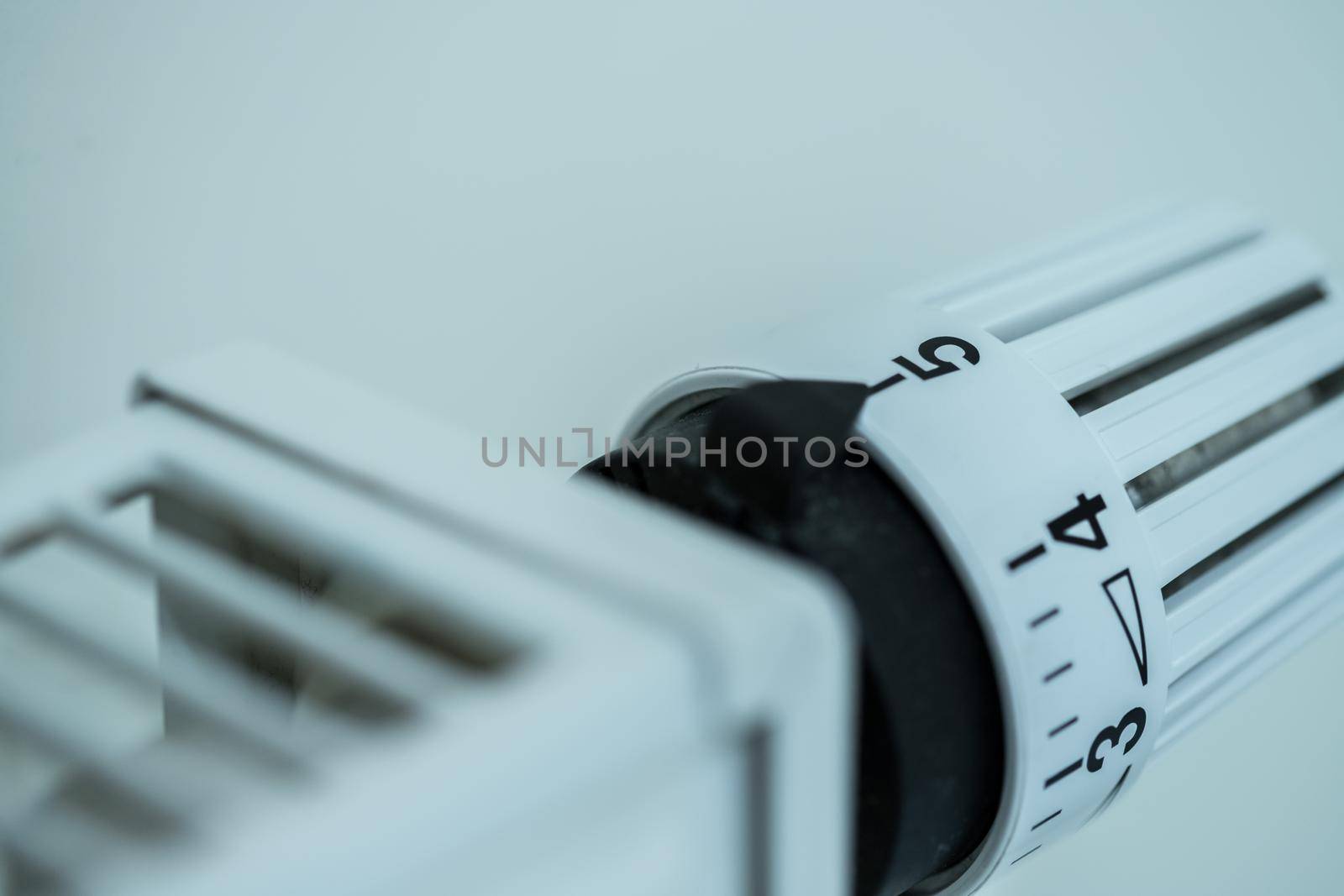 Heat regulator on a heater, close up picture. Heating Costs. by Daxenbichler