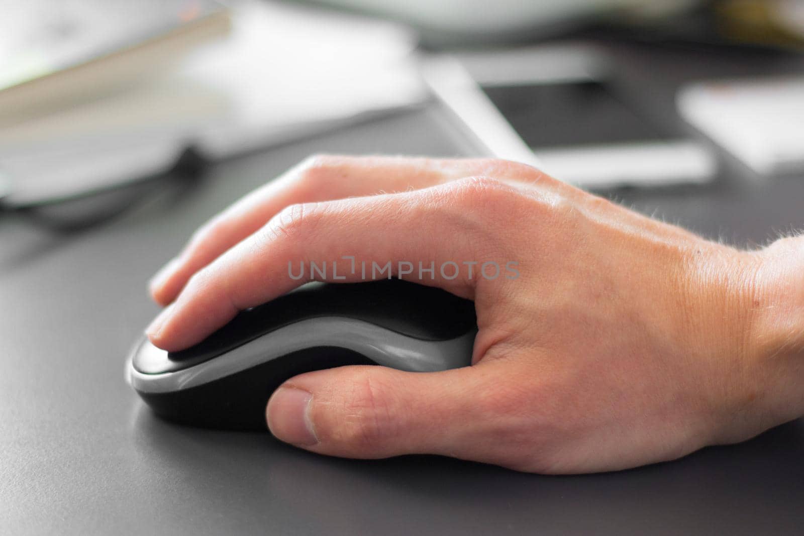 Close up of computer mouse used by a male hand