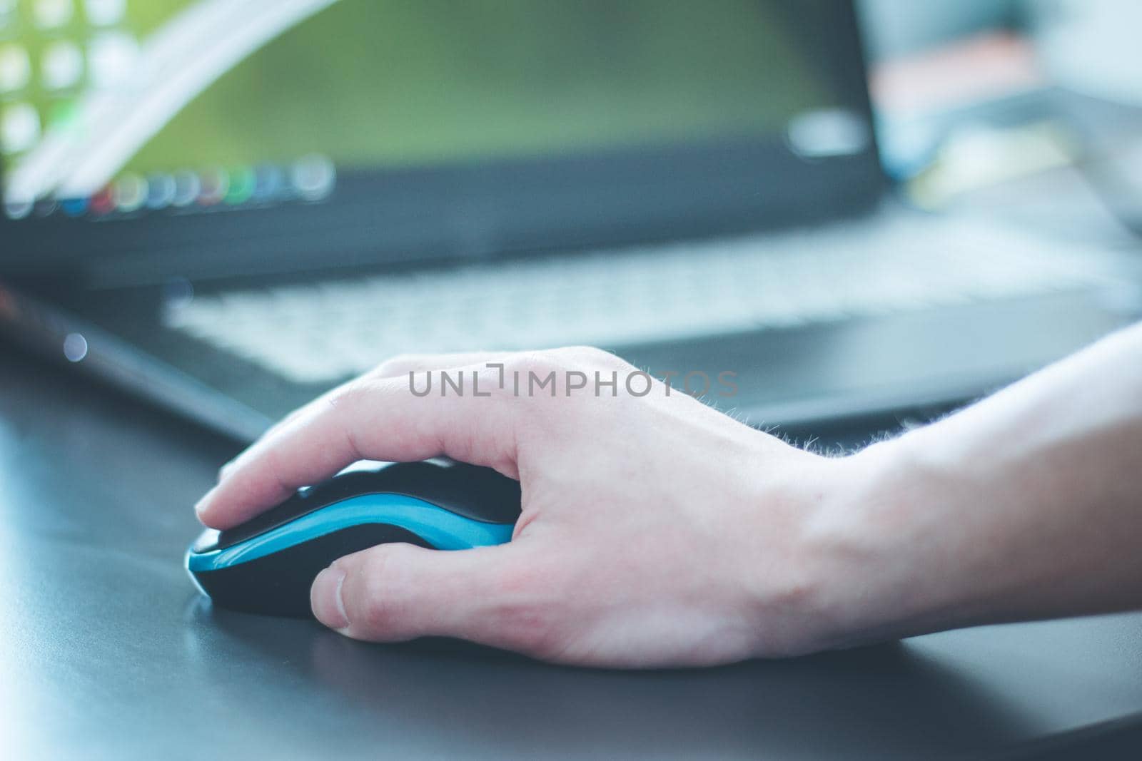 Close up of computer mouse used by a male hand