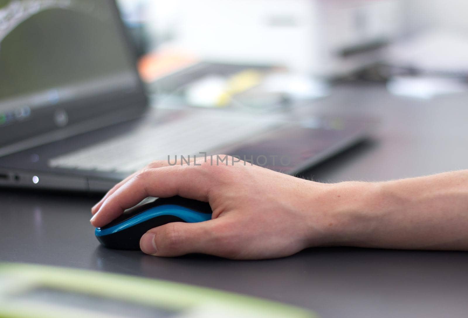 Close up of computer mouse used by a male hand