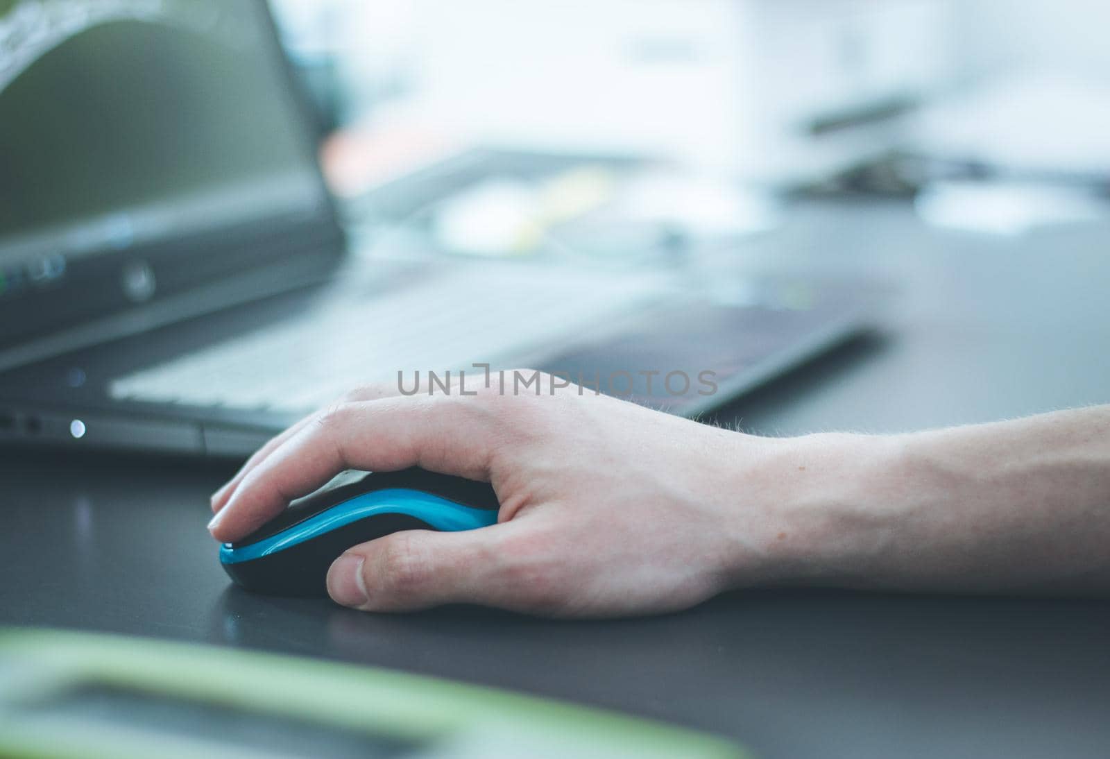 Close up of computer mouse used by a male hand