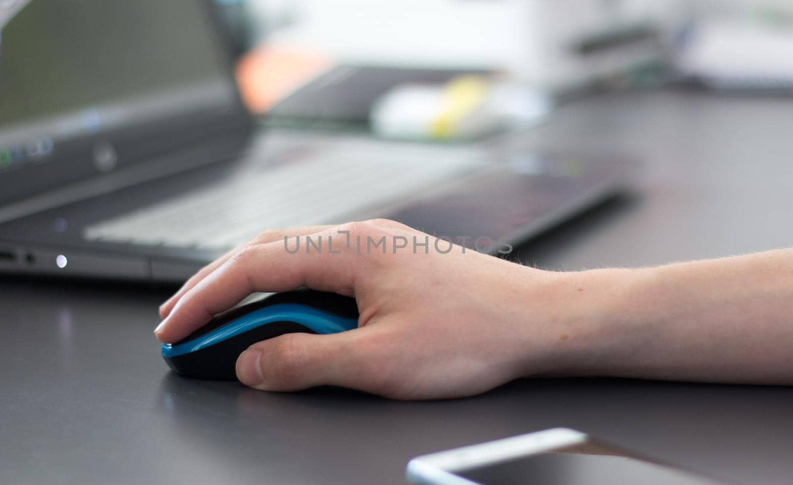 Close up of computer mouse used by a male hand